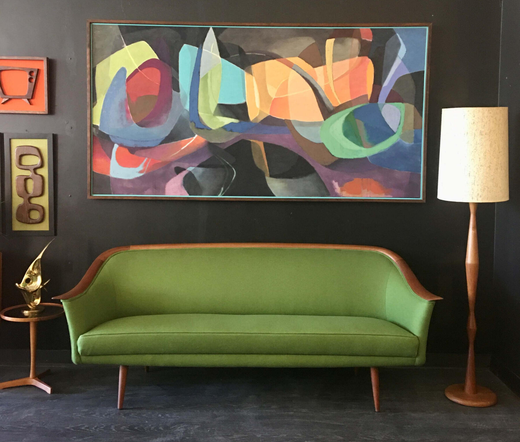 Mid‑century modern green upholstered sofa with wooden frame. Trusted mid-century buyers Mr. Mansifled Vintage Edmonton